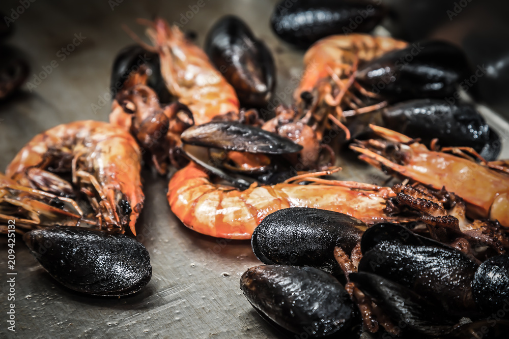 Seafood for frying on a metal background on a professional restaurant kitchen. Selective focus. Shallow depth of field. Toned Seafood for frying on a metal background on a professional restaurant kitchen. Selective focus. Shallow depth of field. Toned