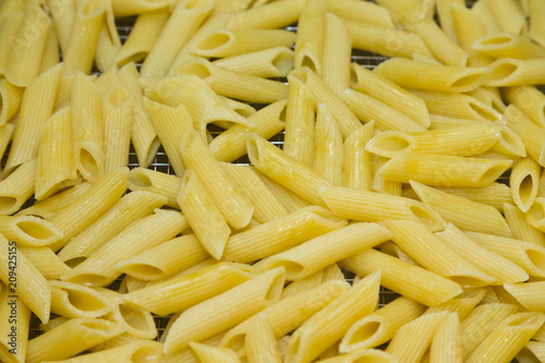 Many pasta pieces on a metal background. Selective focus. Shallow depth of field