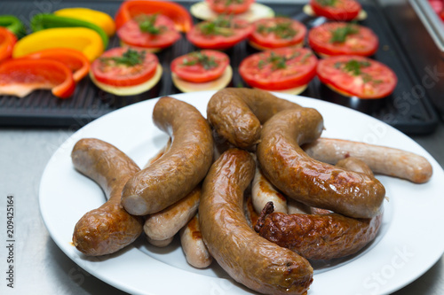 Sausages for frying in metal dishes on a professional restaurant kitchen. Selective focus. Shallow depth of field