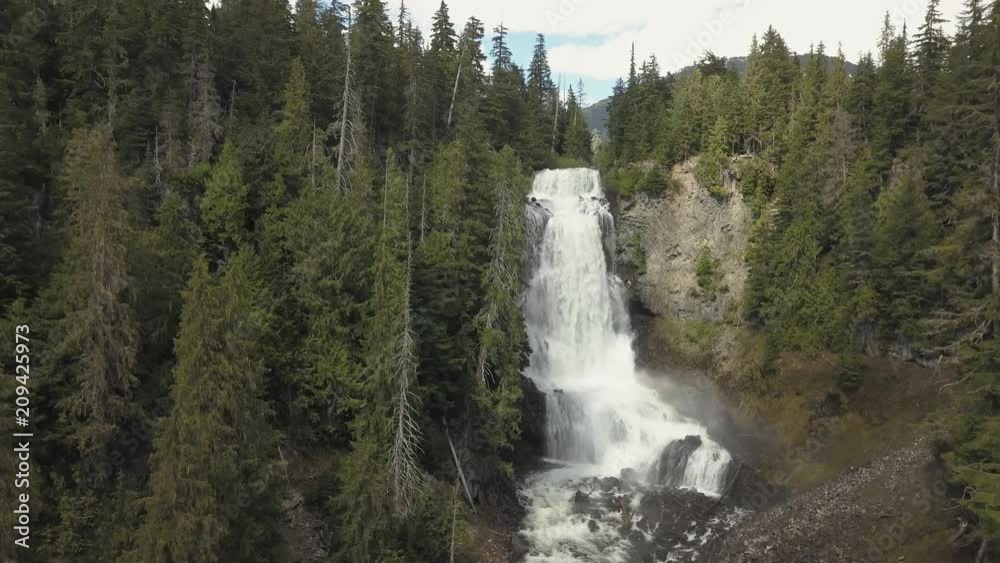 Aerial view of the beautiful waterfall, Alexander Falls, during a sunny summer day. Located near Squamish and Whistler, North of Vancouver, British Columbia, Canada. Aerial view of the beautiful waterfall, Alexander Falls, during a sunny summer day. Located near Squamish and Whistler, North of Vancouver, British Columbia, Canada.