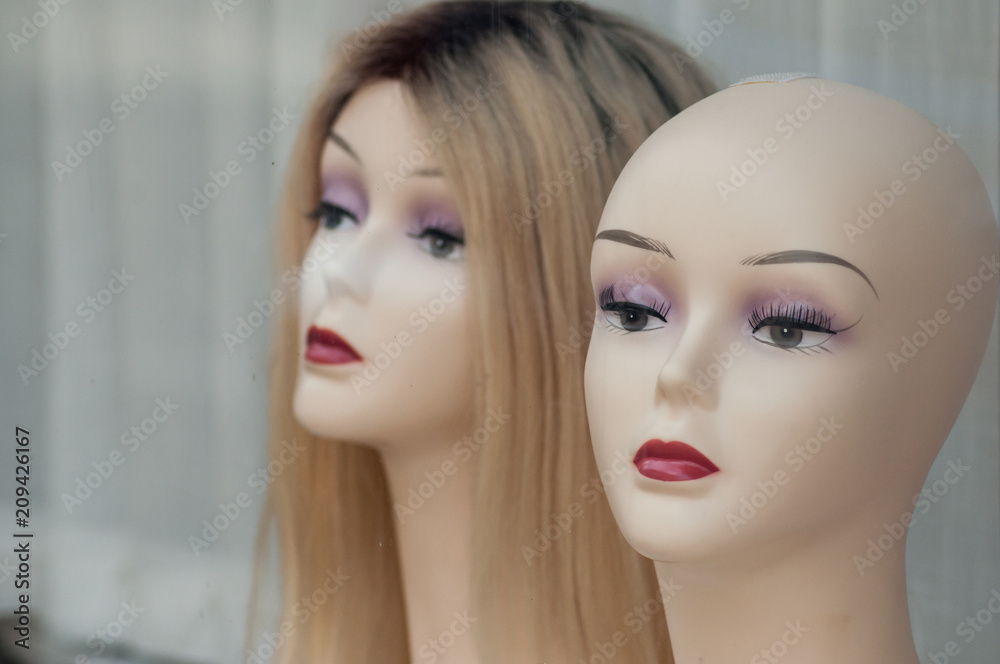 closeup of woman face of mannequin with wig in fashion store showroom closeup of woman face of mannequin with wig in fashion store showroom