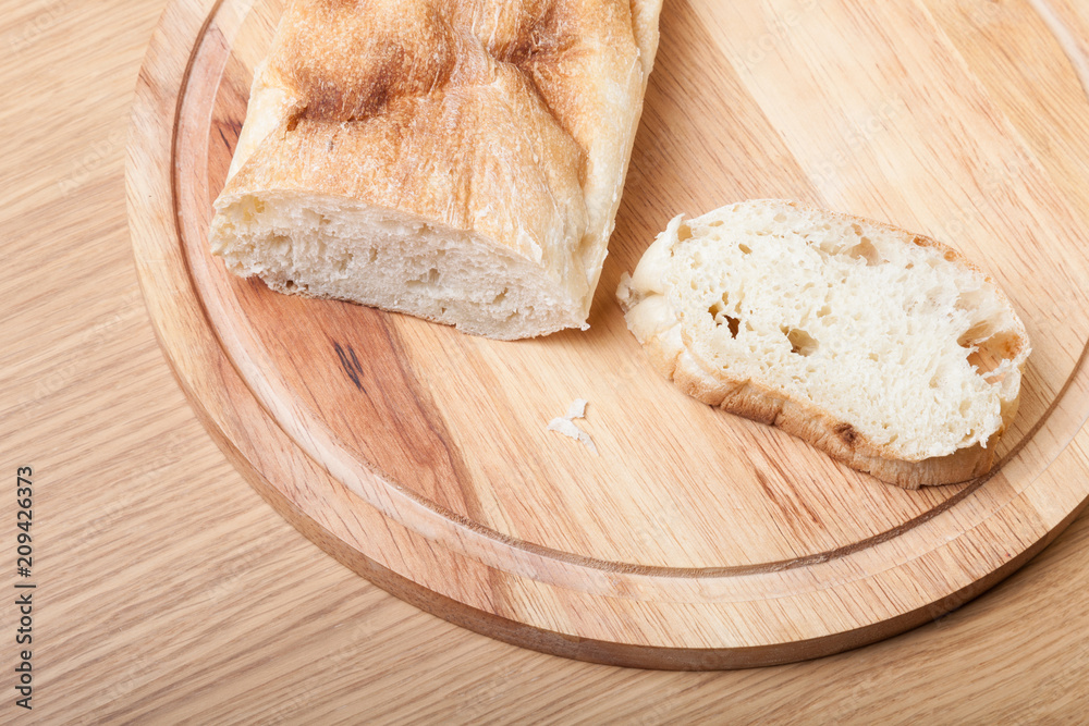 Fresh bread on wooden cutting board Fresh bread on wooden cutting board