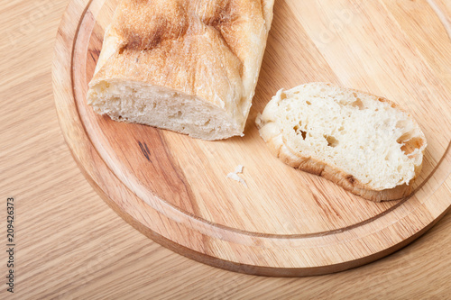 Fresh bread on wooden cutting board