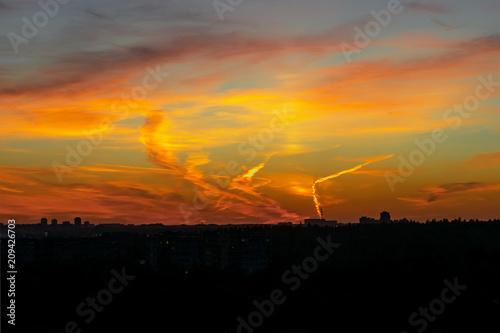 silhouetted city on sunset background photo