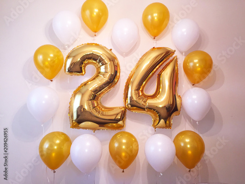 Decoration of the photo zone with gold and white helium balloons. , Birthday present for a cute girl. 24 years old