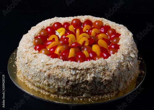 Non-sweet holiday cake with red fish, cherry tomatoes, cream cheese and yellow pepper on dark background photo