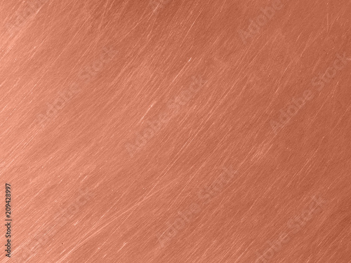 Copper metal texture with circular scratches.