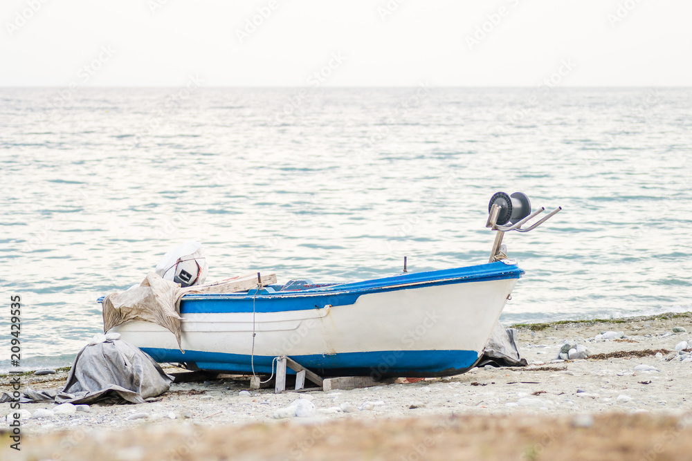 Leptokarya, Greece - June 09, 2018: Drawn boat on the coast Leptokarya, Greece - June 09, 2018: Drawn boat on the coast
