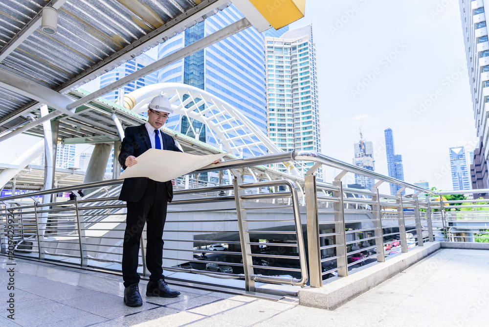 Asian business and engineer man has planning and working for design buiding and city. Asian business and engineer man has planning and working for design buiding and city.