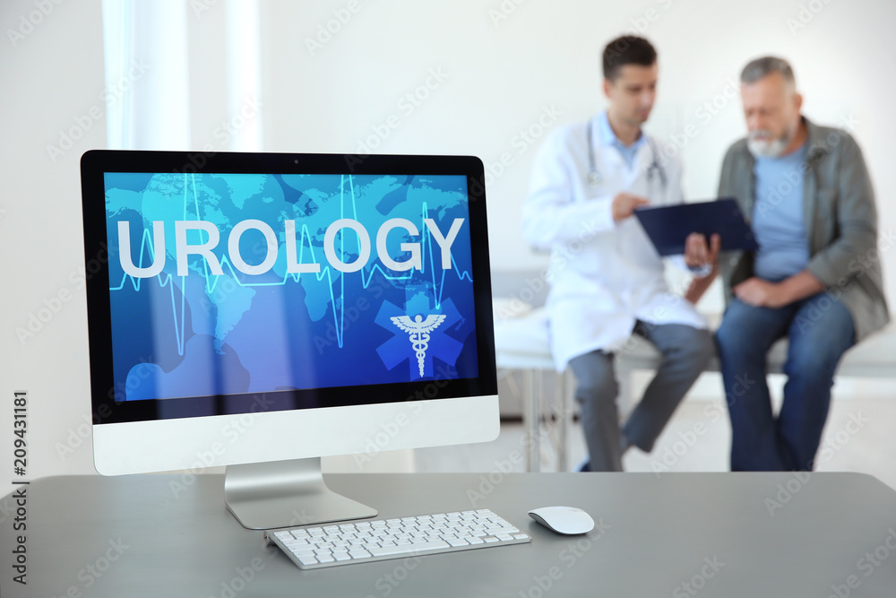 Computer monitor with word UROLOGY and blurred people on background Computer monitor with word UROLOGY and blurred people on background