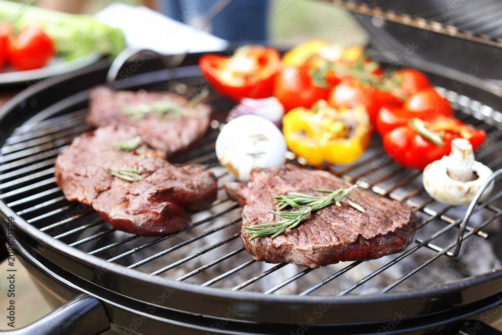 Modern grill with meat and vegetables outdoors, closeup