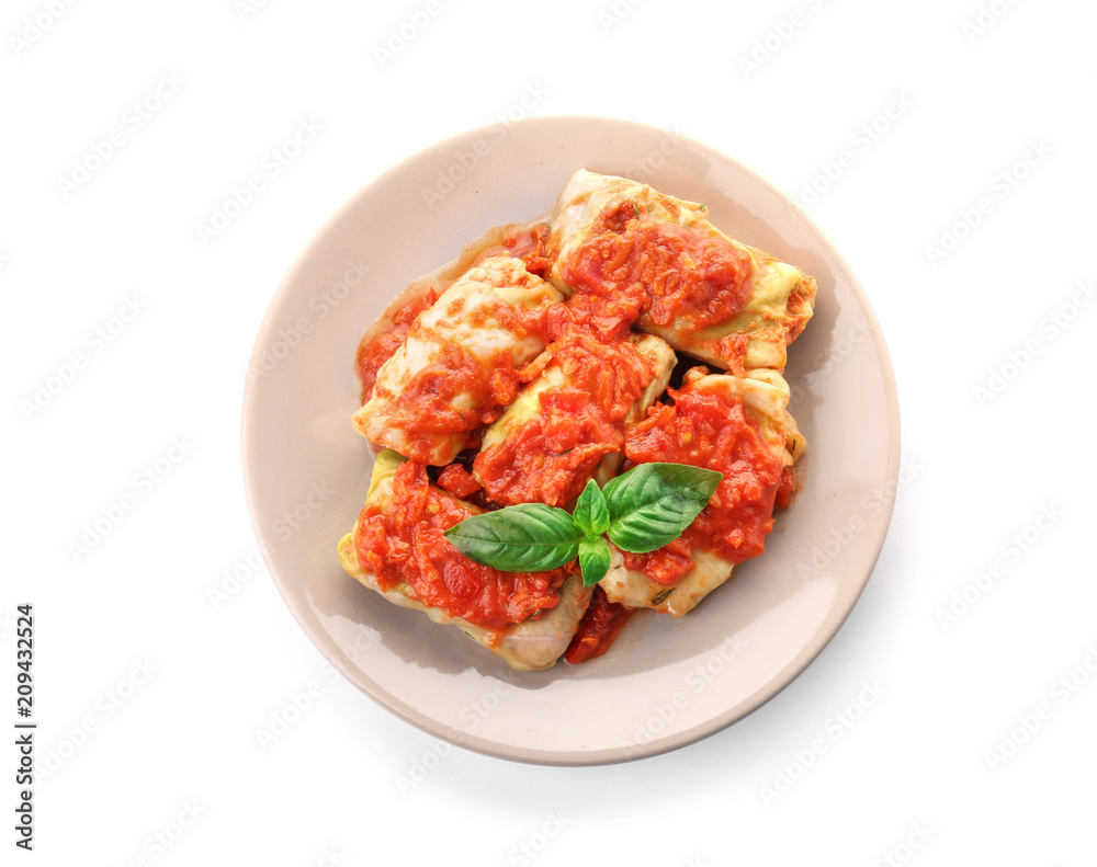 Stuffed cabbage leaves with minced meat and rice in tomato sauce on white background Stuffed cabbage leaves with minced meat and rice in tomato sauce on white background