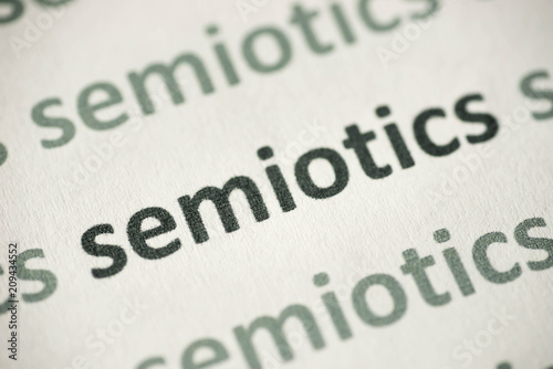 word semiotics printed on paper macro photo