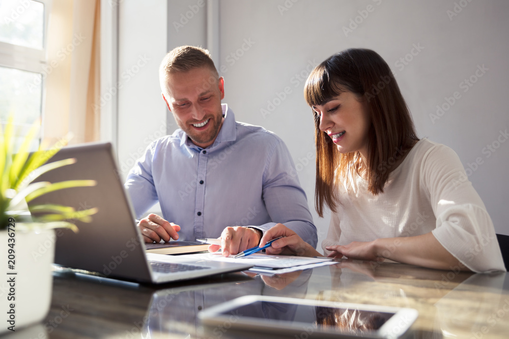 Two Businesspeople Working On Document Two Businesspeople Working On Document