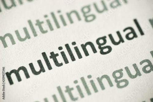 word multulingual printed on paper macro photo