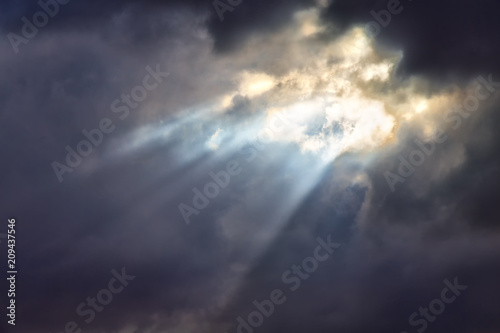 in the cloudy sky a ray of light
