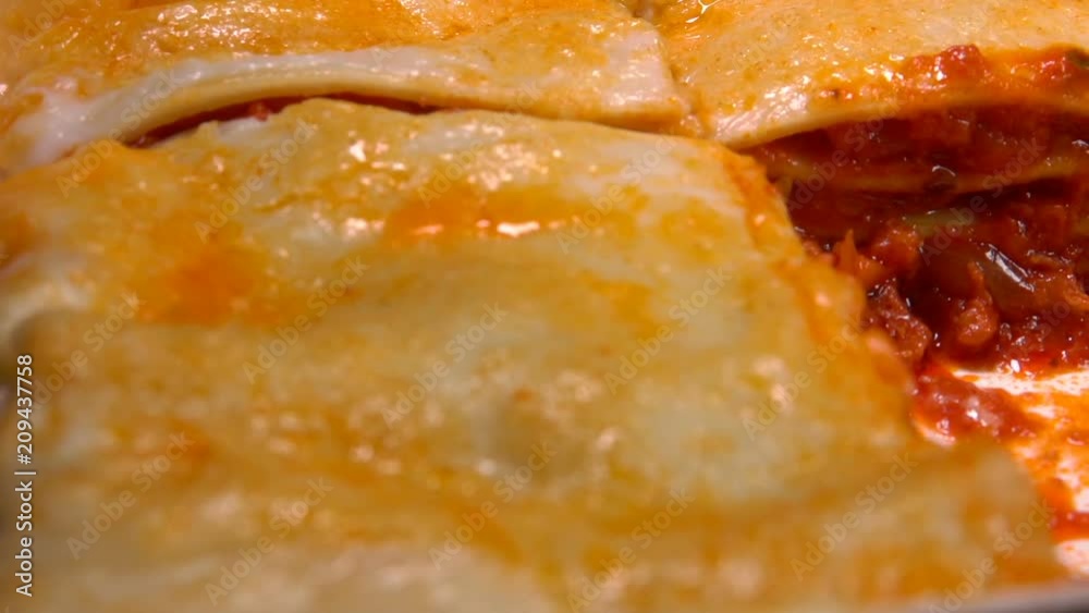 Super close-up a piece of the delicious Italian lasagna taken out with a spatula Super close-up a piece of the delicious Italian lasagna taken out with a spatula