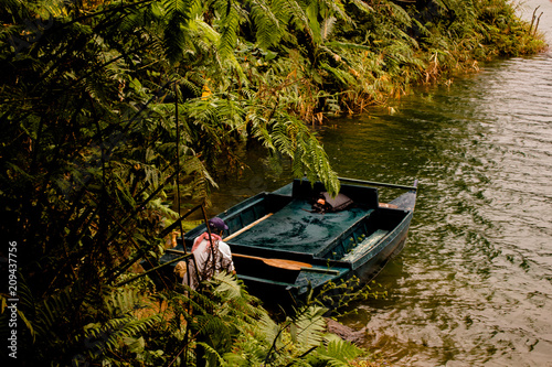 Man holding a boat on the lake photo