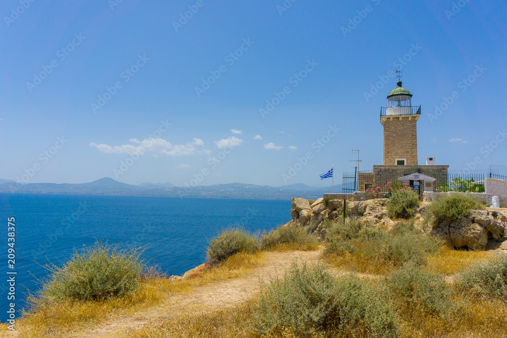 Melagavi lighthouse with endless blue sea in the background in Loutraki, Peloponnese Greece