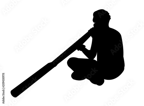 Aborigine man playing a didgeridoo photo