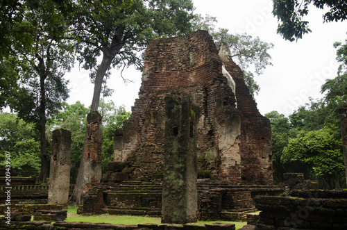 View landscape of buddha statue at Wat Phra Si Iriyabot in ancient building and ruins city of Kamphaeng Phet Historical Park photo