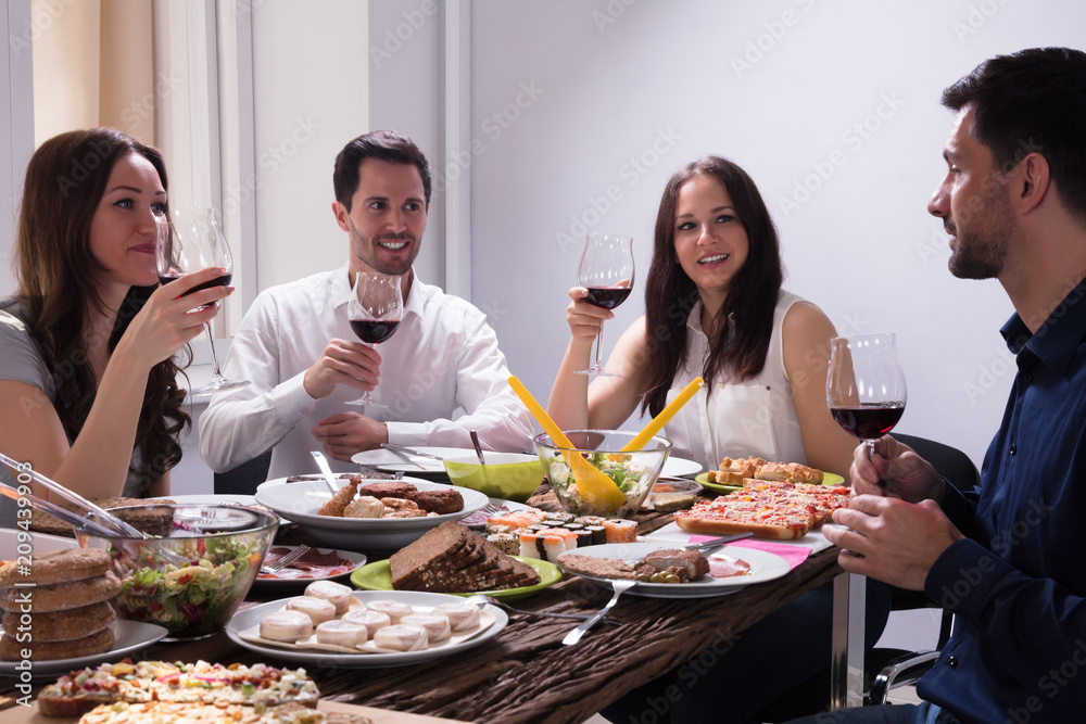 Friends Enjoying Food With Glass Of Wine