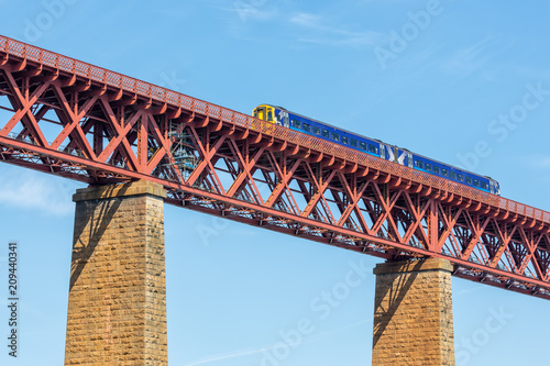 Forth Bridge, railway bridge over Firth of Forth near Queensferry in Scotland with train passing the bridge