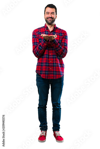 Handsome man holding copyspace imaginary on the palm