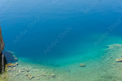 Blue crystal waters at a small beach near archaeological site of Heraion, sanctuary of goddess Hera, in Perachora, Loutraki, Greece