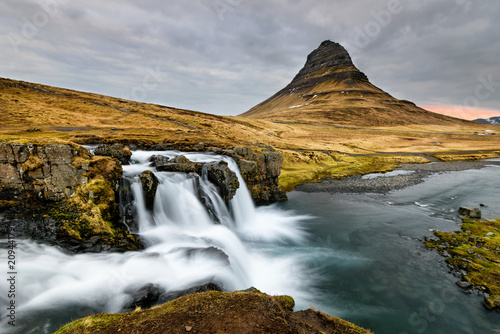 Amazing Icelandic landscape at the top of Kirkjufellsfoss waterfall with Kirkjufell mountain in the background on the north coast of Iceland Snaefellsnes peninsula