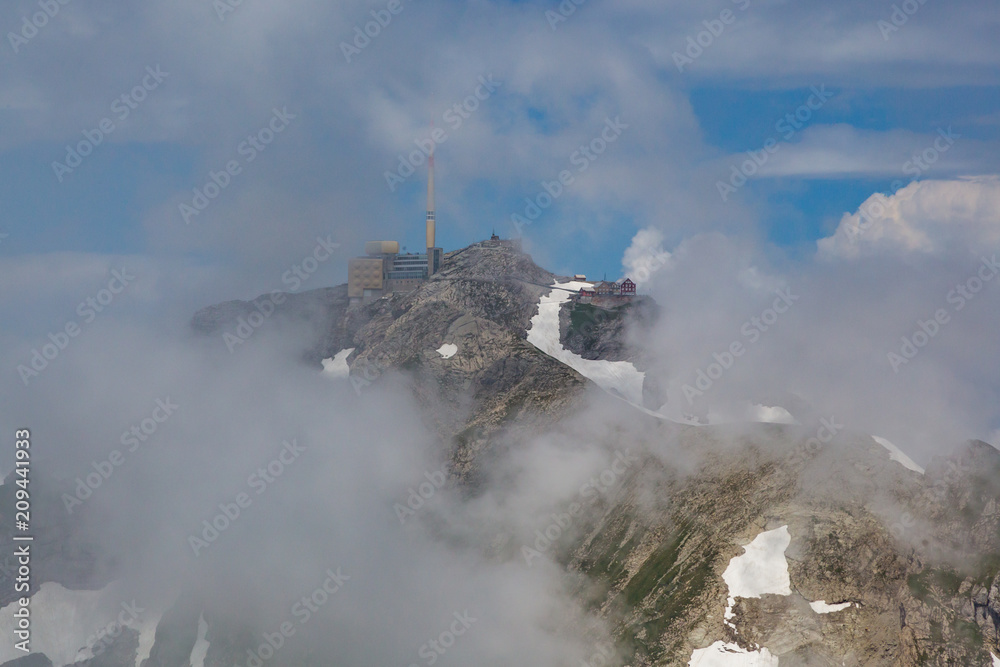 Fototapeta premium top of säntis mountain in switzerland, clouds and blue sky