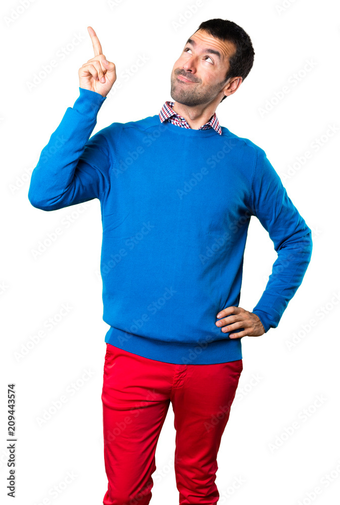 Handsome young man pointing up on white background Handsome young man pointing up on white background