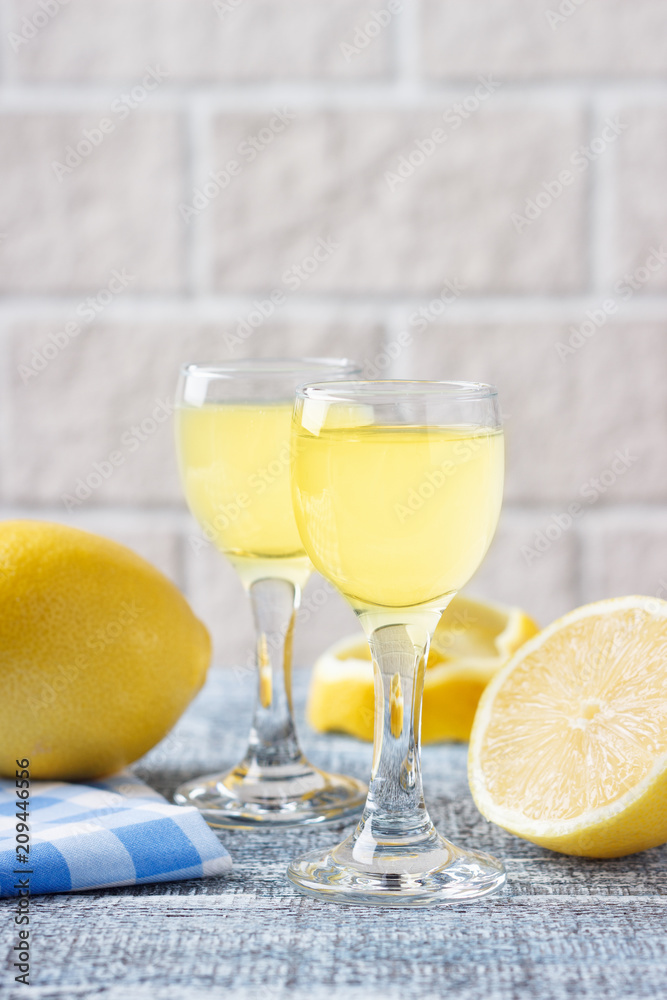 Italian traditional liqueur limoncello with lemon Italian traditional liqueur limoncello with lemon