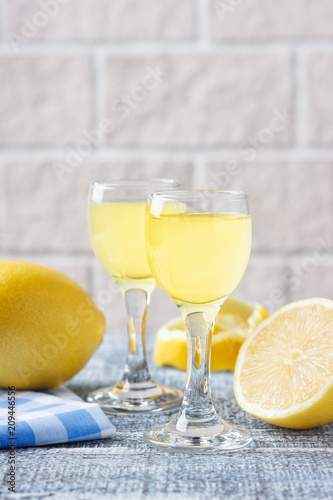 Italian traditional liqueur limoncello with lemon