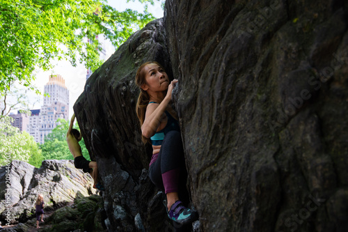 Woman bouldering on a rock, Central Park, New York