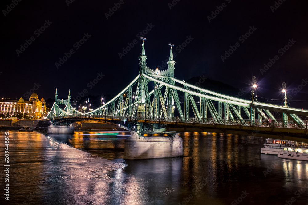 Budapest night urban view with bridge in waterfront city district and Danube river