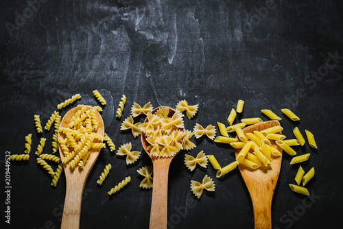 A variety on raw pasta on black background
