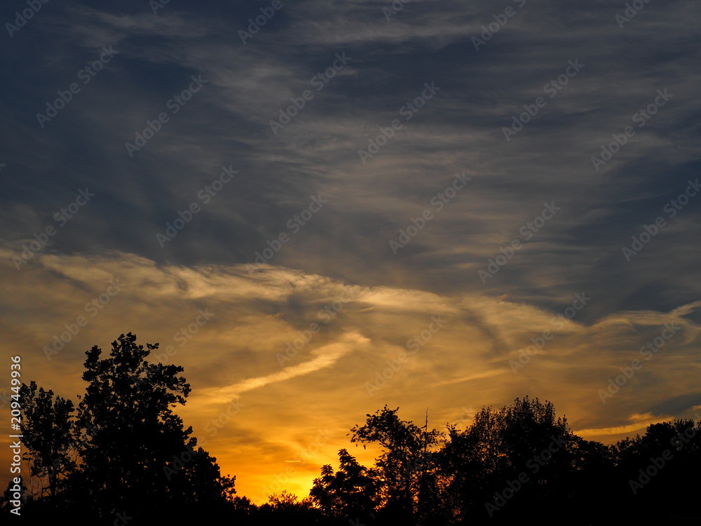 early summer sunset with clouds early summer sunset with clouds
