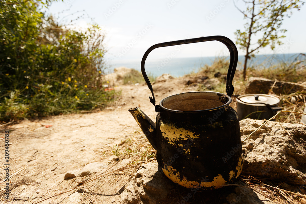 Kettle in a tent camp. Travel and adventure time. Kettle in a tent camp. Travel and adventure time.