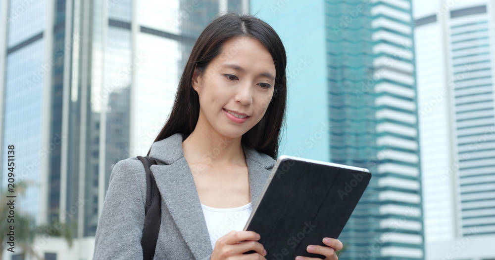 Businesswoman use of tablet computer in city Businesswoman use of tablet computer in city