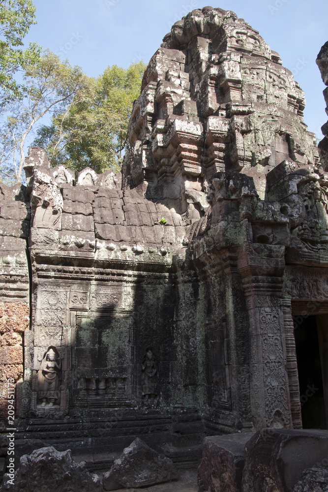 Siem Reap Cambodia, carvings on the walls and tower of a building in the 12th Century Ta Som temple complex