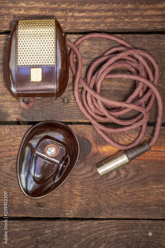 Close up shot of a antique 50s microphone with cables and box, vintage styleconcept. photo