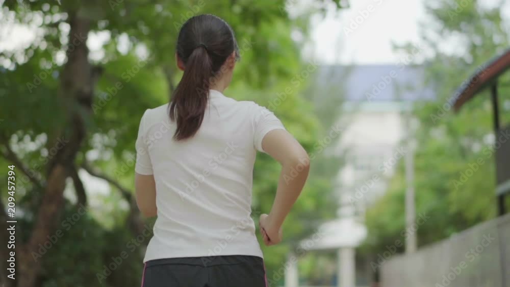 slow-motion of young woman running in park slow-motion of young woman running in park