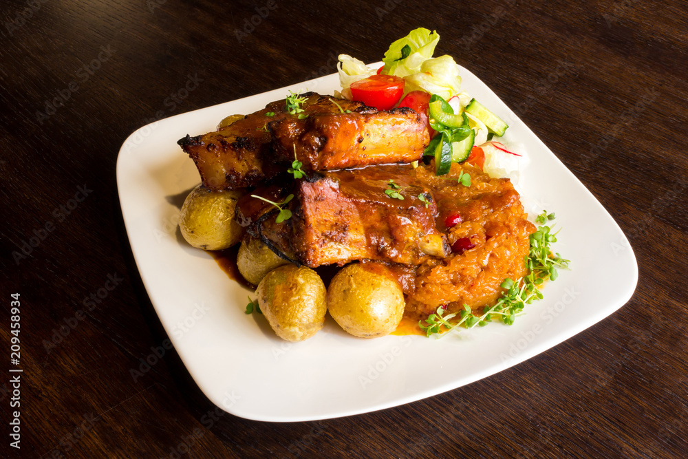 Dish with pork ribs and vegetables Dish with pork ribs and vegetables