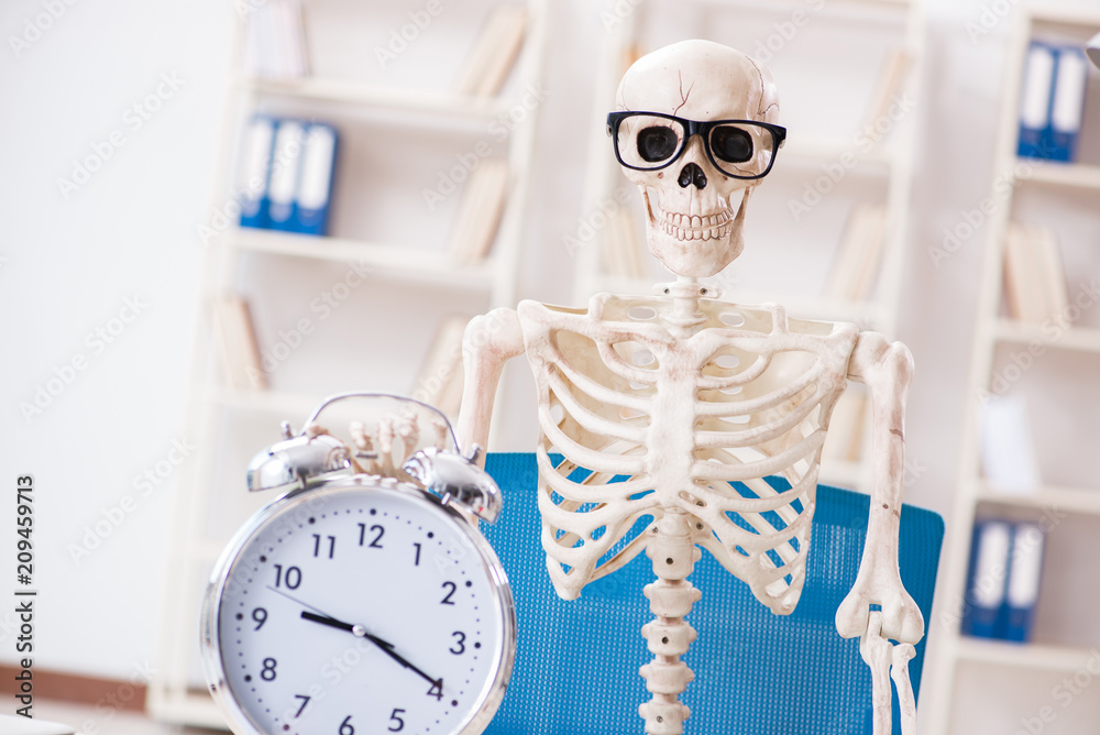 Skeleton businessman working in the office Skeleton businessman working in the office
