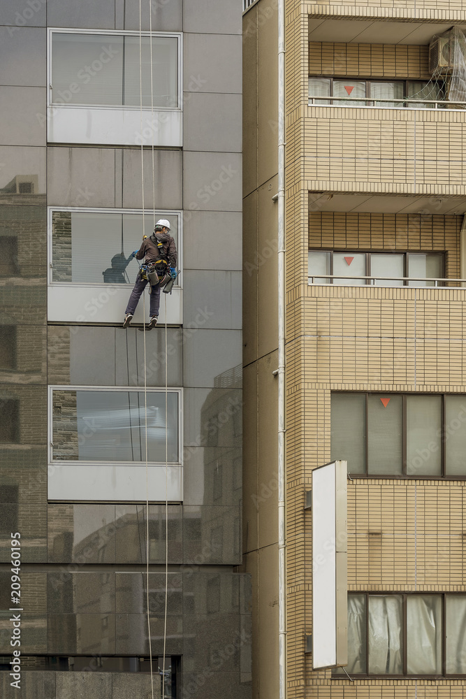 custom made wallpaper toronto digitalWindow washer working at building outdoor hanging on rop, Tokyo, Japan