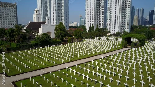 Slow aerial view of serene cemetery for fallen Dutch citizens and soldiers at Menteng Pulo war memorial in Jakarta photo