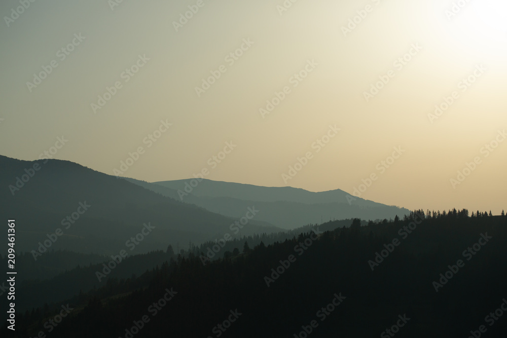 panoramic view of of mountains in misty forest.