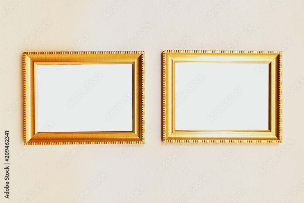 Blank golden picture frame on wall background Blank golden picture frame on wall background