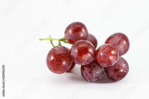 Red grapes on white background.